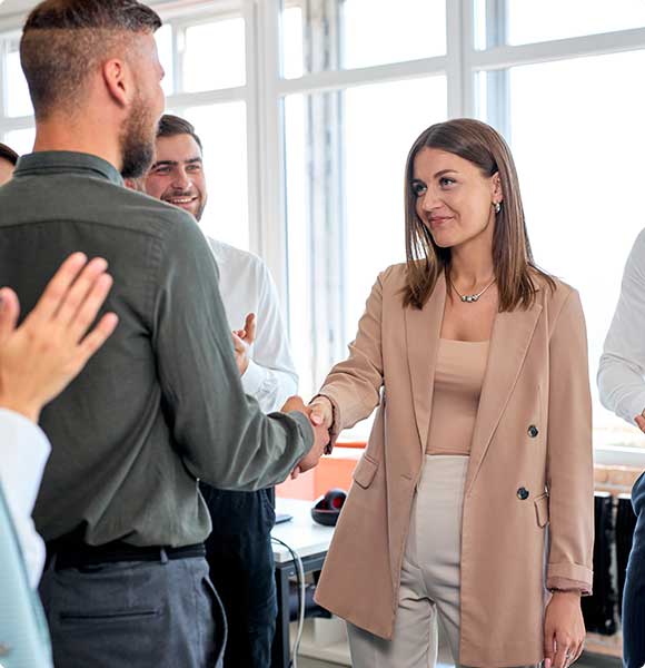 Professional woman and man shaking hands - Careers with Stock & Option Solutions.